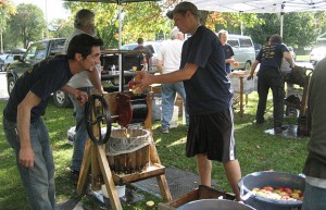 Volunteers at SAGE Make a Difference Day/ Family of Woodstock Apple Festival pressing apple into cider which was donated to local food pantries.